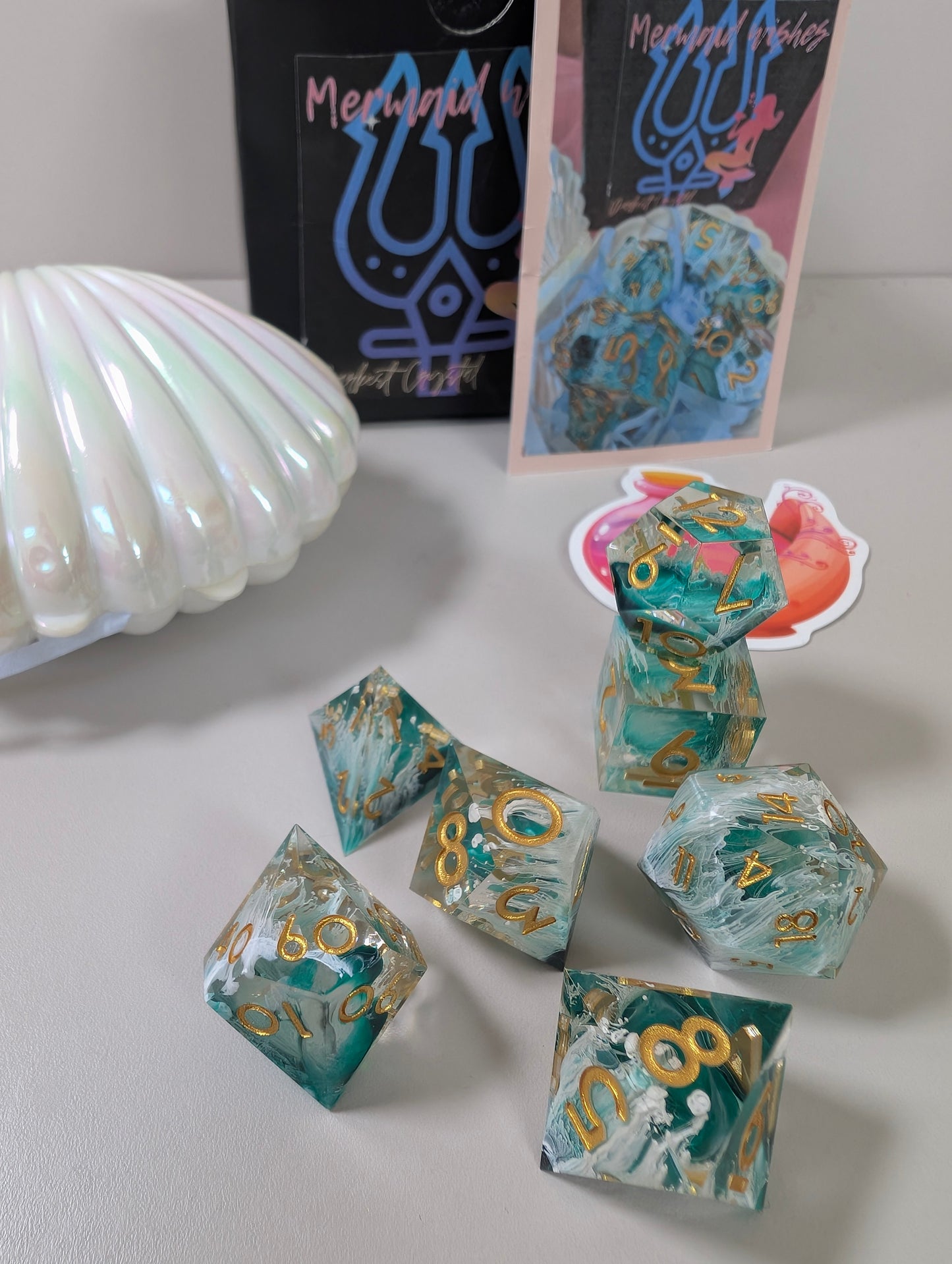 Mermaid wishes ttrpg polyhedral dice gift set, sea waves design in clam shell case